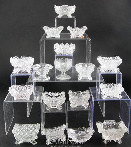 Collection of 17 Glass Salts: Collection of 17 lacy and EAPG pressed glass salts, Boston and Sandwich Glass Co. and others, second half of 19th century, plentiful to rare, various sizes. Three with chips, one with damaged foot, on