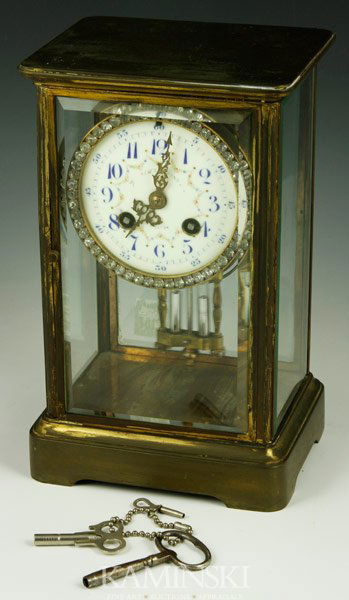 Early 20th C. French Mantel Clock: Early 20th century French brass mantel clock with beveled glass, hand decorated porcelain dial and mercury pendulum with original key, 9 7/8" h x 6" w x 5" d. Operational condition unknown.