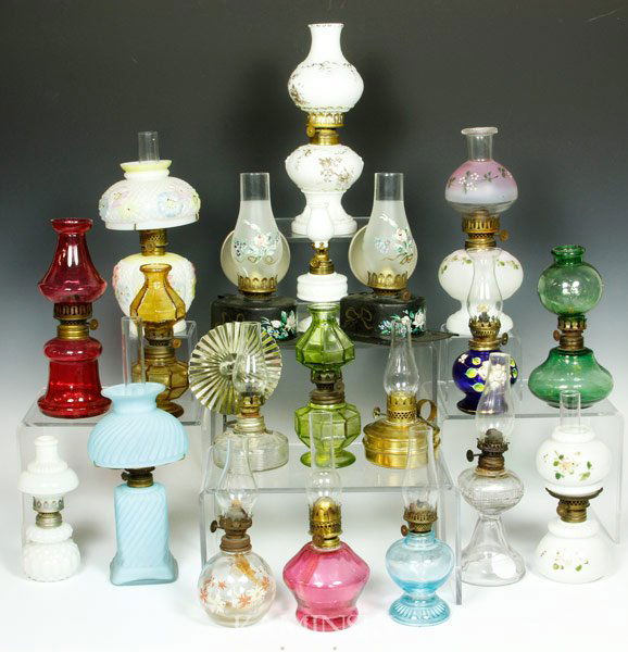 Collection of 20 Miniature Oil Lamps: Collection of twenty miniature oil lamps, to include milk glass, cranberry, brass, pattern glass, cosmos, cobalt, green, 'twinkle', satin glass, "Improved Banner" tole, etc, tallest 11" h.