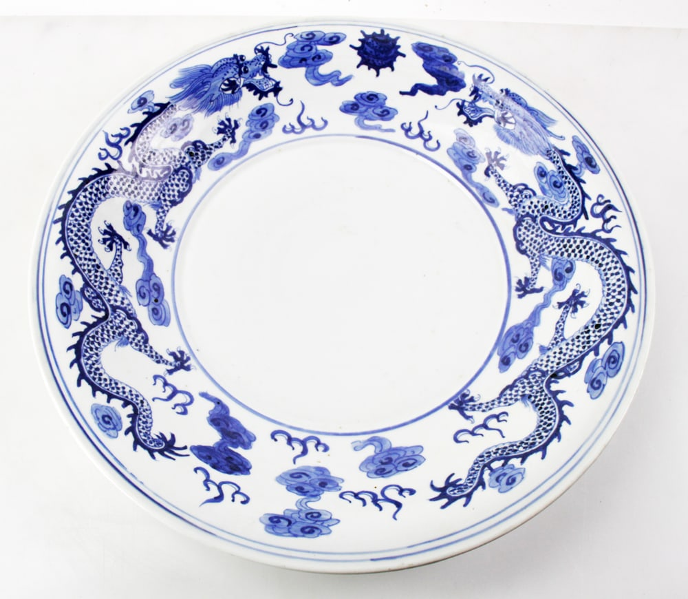 Chinese Porcelain Pedestal with Dragon Charger: Chinese blue and white porcelain pedestal with dragon charger, pedestal 27" H, charger 19" diameter. Provenance: Estate of Kenneth Moore, Pompano Beach, Florida.