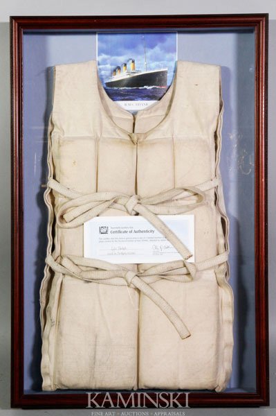 "Titanic", Life Preserver from the Movie: "Titanic", Life preserver from the movie of the same name, used in the sinking scene, complete with certificate of authenticity, framed in glass case.