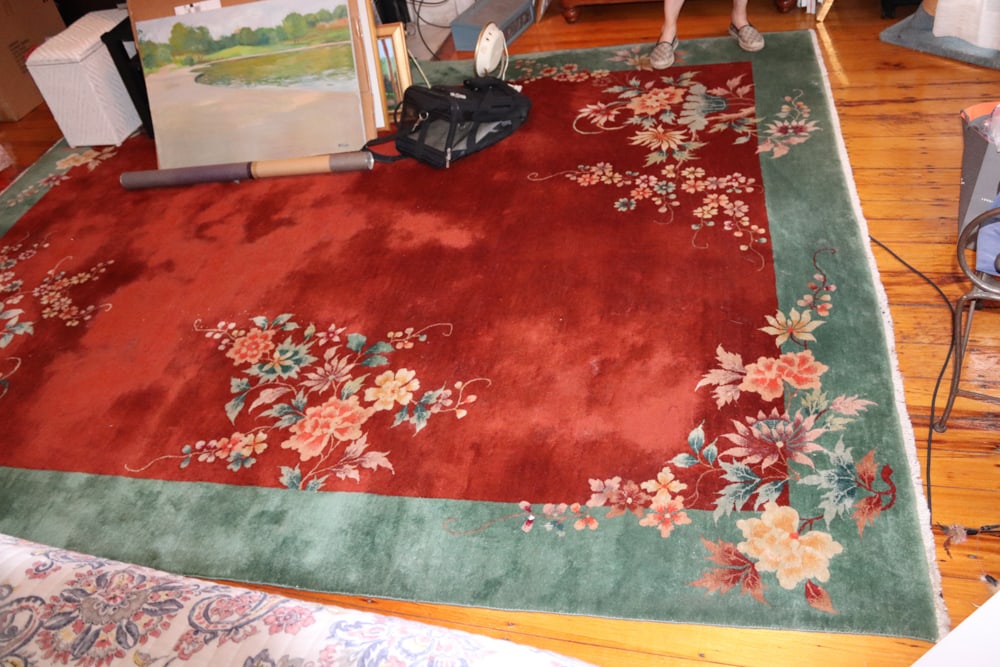 Chinese Carpet with Rust Center Field: Chinese carpet with rust center field and green border, 9' x 10' 8". Provenance: Lifetime personal collection of antiques from 168 W. Canton St., Boston. PLEASE NOTE: Item is to be picked up by the bu
