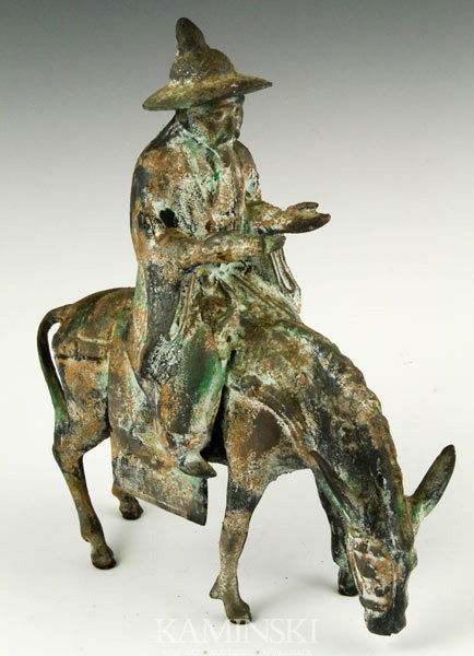 Korean Bronze Figure: Bronze figure, Korea, 19th century, in the form of a man riding on a donkey, 11” h.