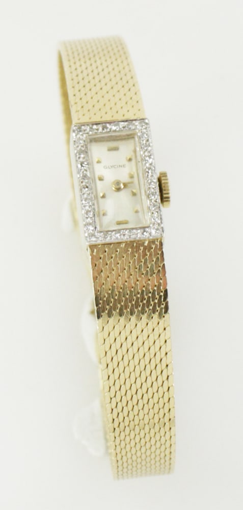 14k Yellow Gold Ladies' Glycine Watch with Diamonds: 14k yellow gold ladies' Glycine watch with diamonds, face 5/8" x 3/8", band 6 5/8" L. Approximately 22 grams TW (including movement). Provenance: Newbury, Massachusetts collection. PLEASE NOTE: paymen