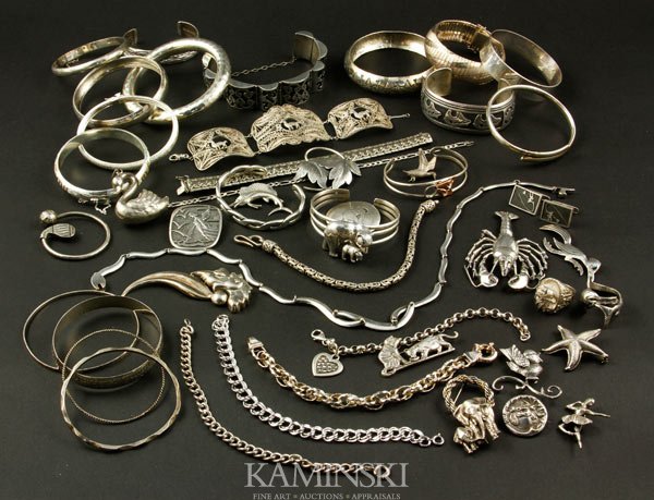 Collection of Sterling Jewelry: Collection of sterling jewelry, to include: two rings; one necklace; fifteen pins; one swan pendant; eight link bracelets; fourteen bangle bracelets; five cuff bracelets; one key holder; one pair cuff