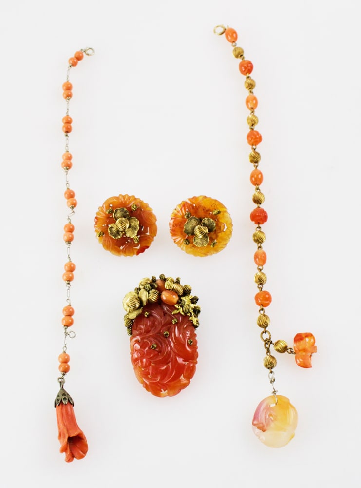 Carved Carnelian Jewelry, Coral Bracelet: Carved carnelian pendant, carved carnelian bracelet, pair of carved carnelian earrings, and coral bracelet. Provenance: San Diego, California collection. PLEASE NOTE: payment for silver, gold, jewelry