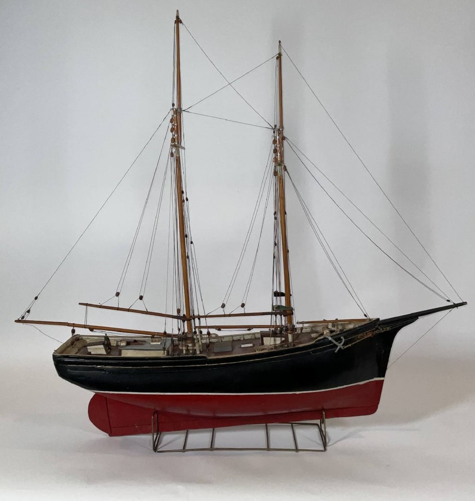Scale Model of a Two-Masted Schooner: Rigged ship model of a two-masted schooner. Rigged with standing and running cords. 44" H x 46" W x 9" D. 18 lbs.
