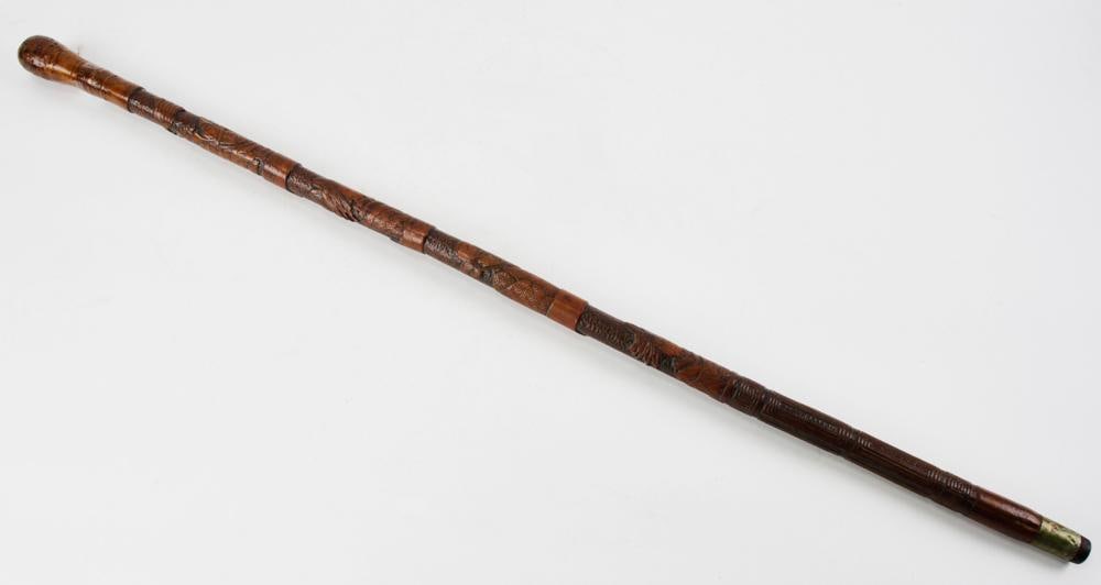 Japanese Meiji Era Carved Boxwood Cane: Japanese Meiji era boxwood cane with metal tip, carved with figures, symbols, and writing, 34 1/2" L. Provenance: Peabody, Massachusetts collection.