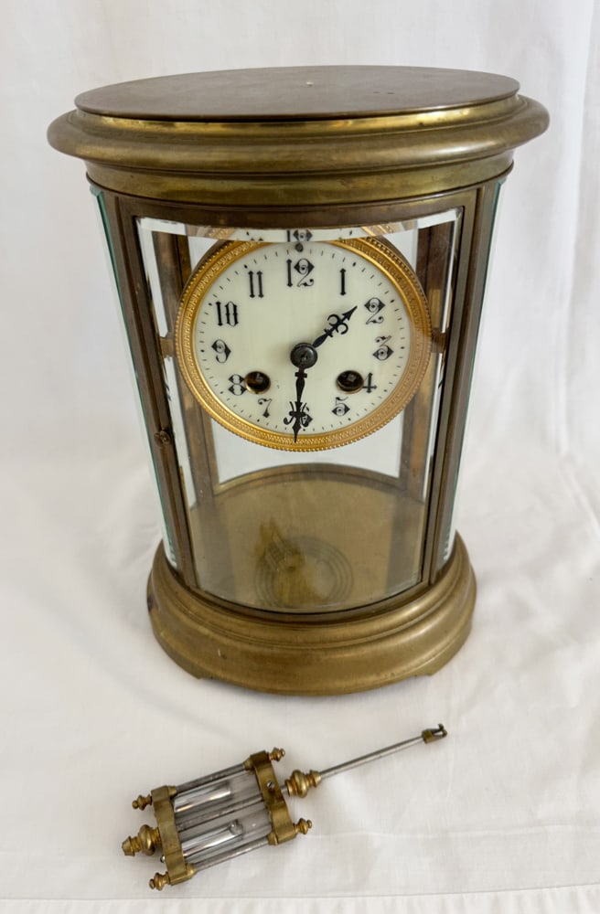 Bronze Mantel Clock with Beveled Glass Case, Pendulum: Bronze mantel clock with beveled glass case and pendulum. Provenance: Estate of Howard D. Monroe, Jr., West Palm Beach, Florida.