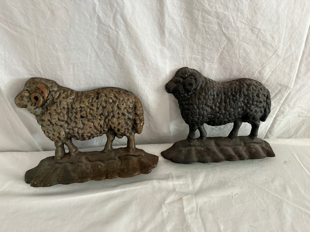 Two Iron Sheep Doorstops: Two iron sheep doorstops, 7" x 10" x 2". Provenance: Estate of Howard D. Monroe, Jr., West Palm Beach, Florida.