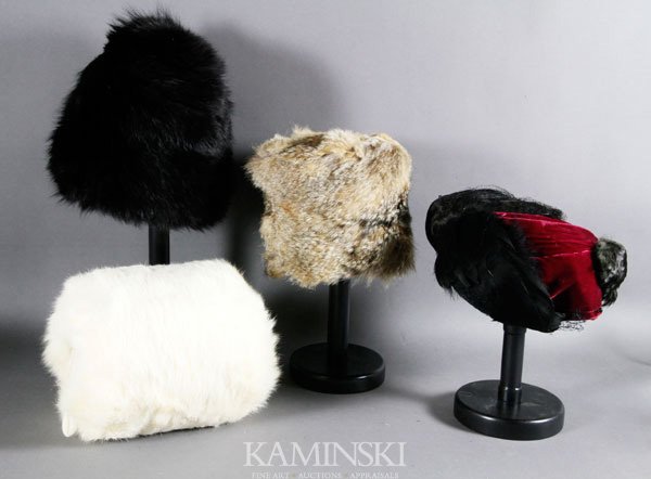 4 Vintage Winter Items: Lot of four vintage winter items to include; one red velvet hat with feathers and veiling; one tall black fur hat; one white fur muff; one fur hat from Dexter's furriers in shades of brown, muff is 8 