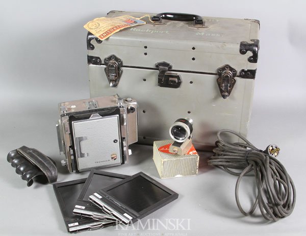 Technika-Linhof Long Format Camera: Technika-Linhof long format camera in box with three (3) film canisters, Angulon 1:6, 8/90 lens, Schneider-Krueznach telescoping viewfinder and pistol grip. Operational condition unknown.