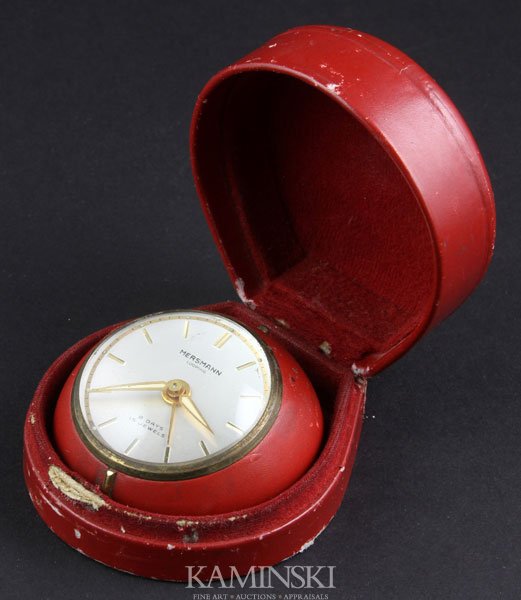 20th C. Travel Clock: 20th century small travel clock with domed crystal dial, marked "Mersmann Looping - 8 days - 15 jewels", in fitted red leatherette case.