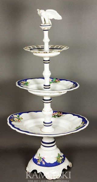 KPM Porcelain Compote: KPM Porcelain three tier compote center piece, hand-painted with eagle finial, 39" h. Some gilt wear.