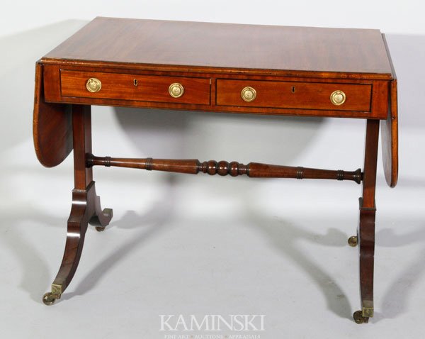 19th C. English Mahogany Sofa Table: 19th century English mahogany two-drawer sofa table having string inlay and brass castors, 29 1/2"h x 37"w x 24"d. 1/2" piece of trim missing from one drawer.