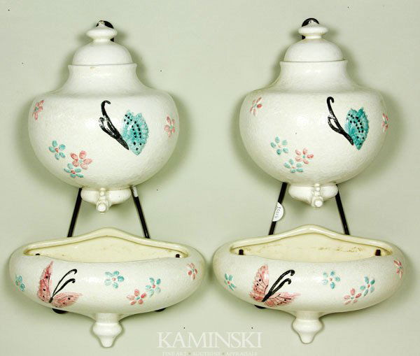 Pair of Hull Pottery Wall Pockets: Pair of Hull Pottery two piece “Lavabo” form wall pockets in the “Butterfly” pattern, along with original wrought iron hangers for each upper section, top sections signed Hull USA B24, bottom
