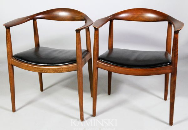 Pair Hans Wegner Armchairs: Pair of Hans Wegner armchairs, "the chair", or "the round chair", light brown finish with black leahter seats, circa 1950s, likely early contract furniture, they are not marked save a 1950s era Uphols