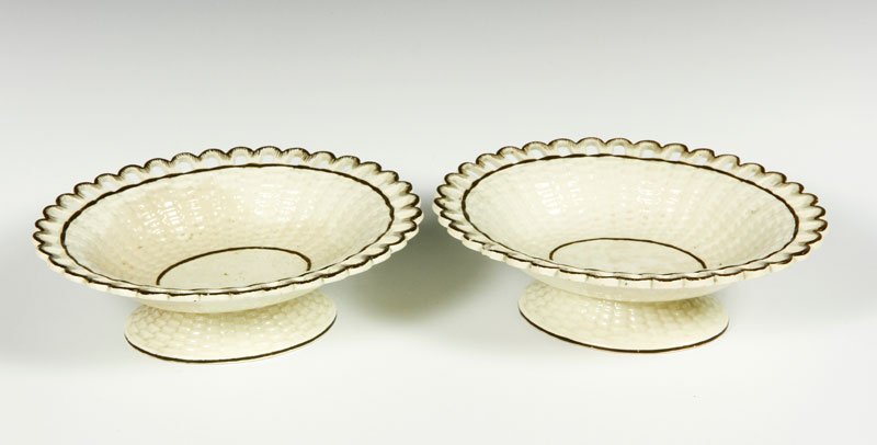 Pair 19th C. Wedgewood Creamware: 19th century, pair of Wedgewood creamware oval small compotes with brown painted rim, basket weave body, 2"h x 7"w x 5 1/2"d.