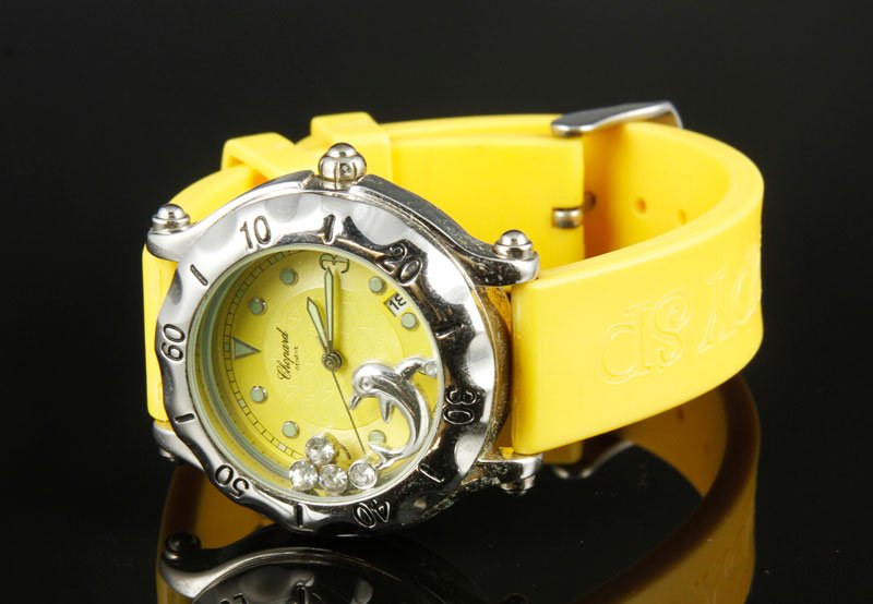 Chopard "Happy Sport" Watch: Chopard "Happy Sport" watch with stainless case and yellow rubber band S/W 32678/1268 9 3/8"L, 1 1/2" dia. Face, operational condition unknown. From the collection of Nayereh Seifi Samii, the first fe