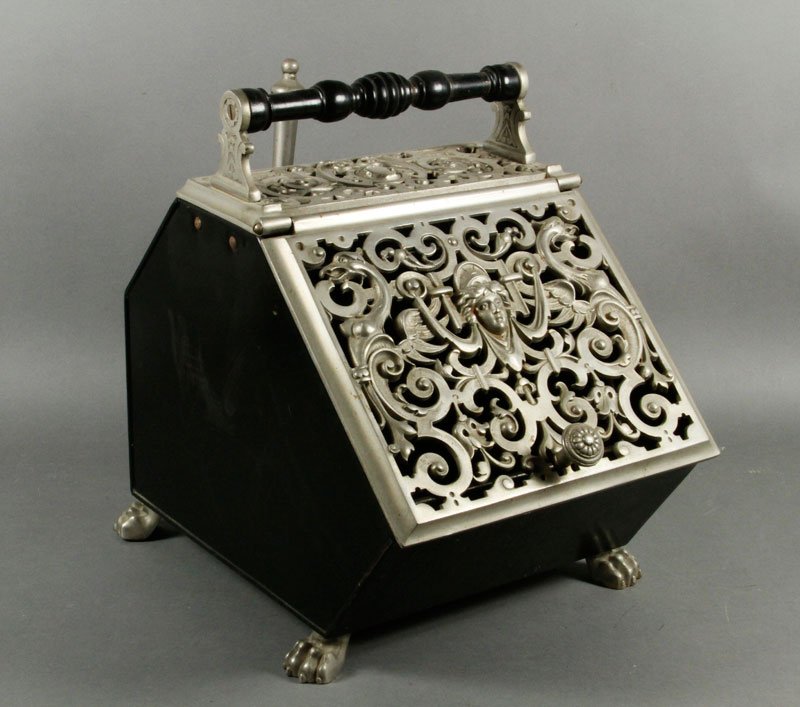 19th C. English Black Tin Coalscuttle: English black tin coalscuttle, rectangular with angled top, with cast steel top plate pierced with cartouche and open scrolls and overhead a turned wood handle, wide hinged angled front lid with pierc