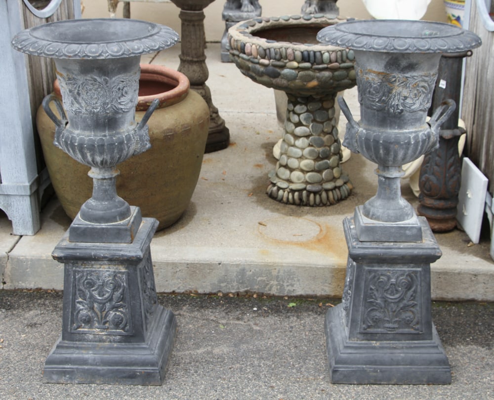Pair of Victorian-style Cast Iron Urns on Pedestals: Pair of Victorian-style cast iron urns on pedestals, 42" H x 19".