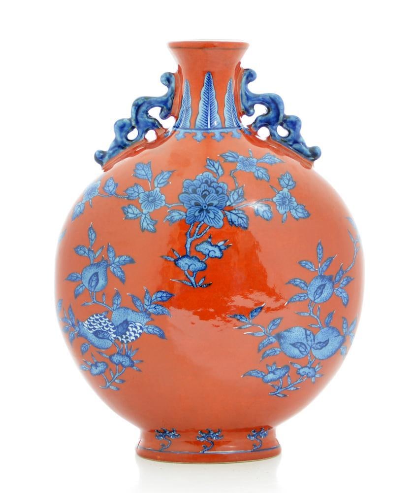 Large Iron-Red Moon Flask Vase: Each side of the vase is decorated in delicate shades of blue with sprays of pomegranate, peach and persimmon alternating with branches of peony, chrysanthemum and lotus, all reserved on a rich iron-r