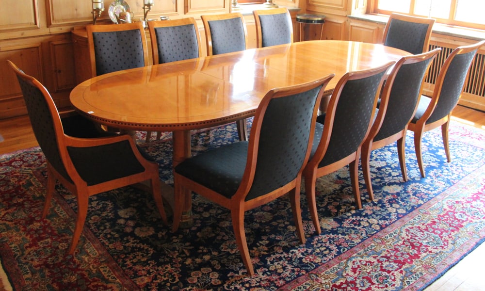 Biedermeier-style Dining Table and Chairs: Biedermeier-style dining room table with (8) side chairs and (2) armchairs, upholstered. Table 29" H x 100" L (with one leaf) x 46" W; extra leaf 19 1/2" W; chairs 30" H x 24" W x 18" D. Provenance: G