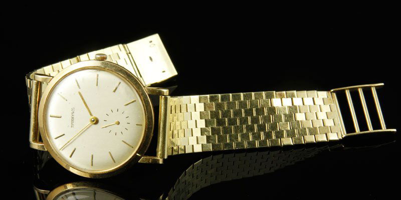 14K Tiffany and Co. Gold Watch: 14K Tiffany and Co. gold watch with Movado movement, approximately 1.8 ounces/ 34 DWT TW including movement, good physical condition, operational condition unknown, reverse engraved with owner's name,