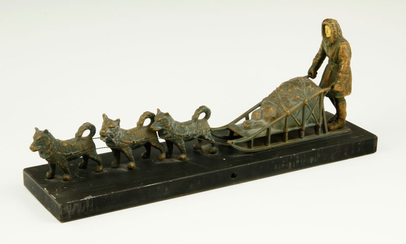 Bronzed White Metal Dog Sled Sculpture on Slate Base: Bronzed white metal dog sled on slate base, 6"x 14" x 3 1/2".
