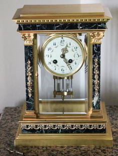 French Neoclassical Brass and Green Marble Mantel Clock: French Neoclassical brass and green marble mantel clock, having painted porcelain face and beveled glass, 12" H x 9" W x 5" D. Key and mercury pendulum included. Provenance: Gloucester, Massachusetts