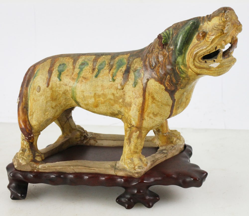 Old Chinese Sancai Glazed Pottery Tiger on Stand: Old Chinese Sancai glazed pottery tiger on wood stand, 8" x 9". Provenance: Methuen, Massachusetts estate.