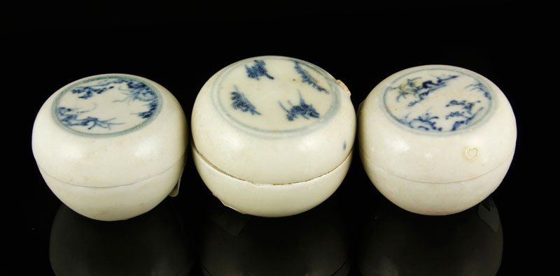 Vietnamese Blue and White Covered Boxes: Lot of three small blue and white covered boxes, Vietnam, 15th century, some decorated with a mountain and cloud motif, largest 1 1/2" dia. From the Hoi An shipwreck; a very important record of the ty