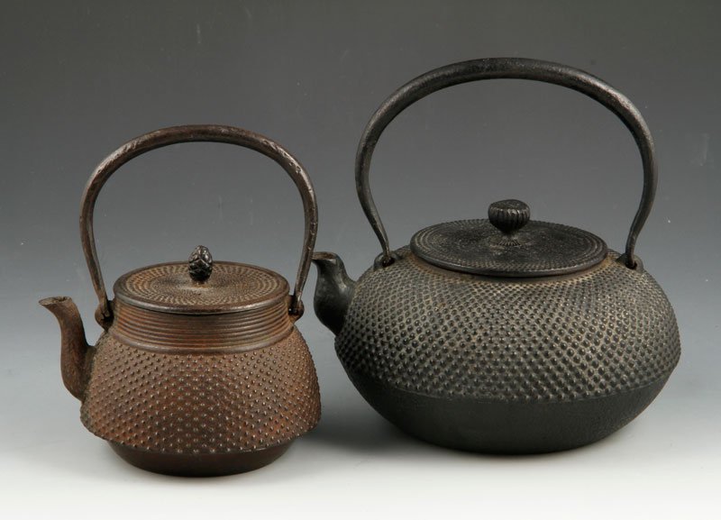 Japanese Iron Teapots: Two iron teapots, Japan, one with artist's signature, one 6 1/2" x 7", the other 4 1/2" x 5 1/2".