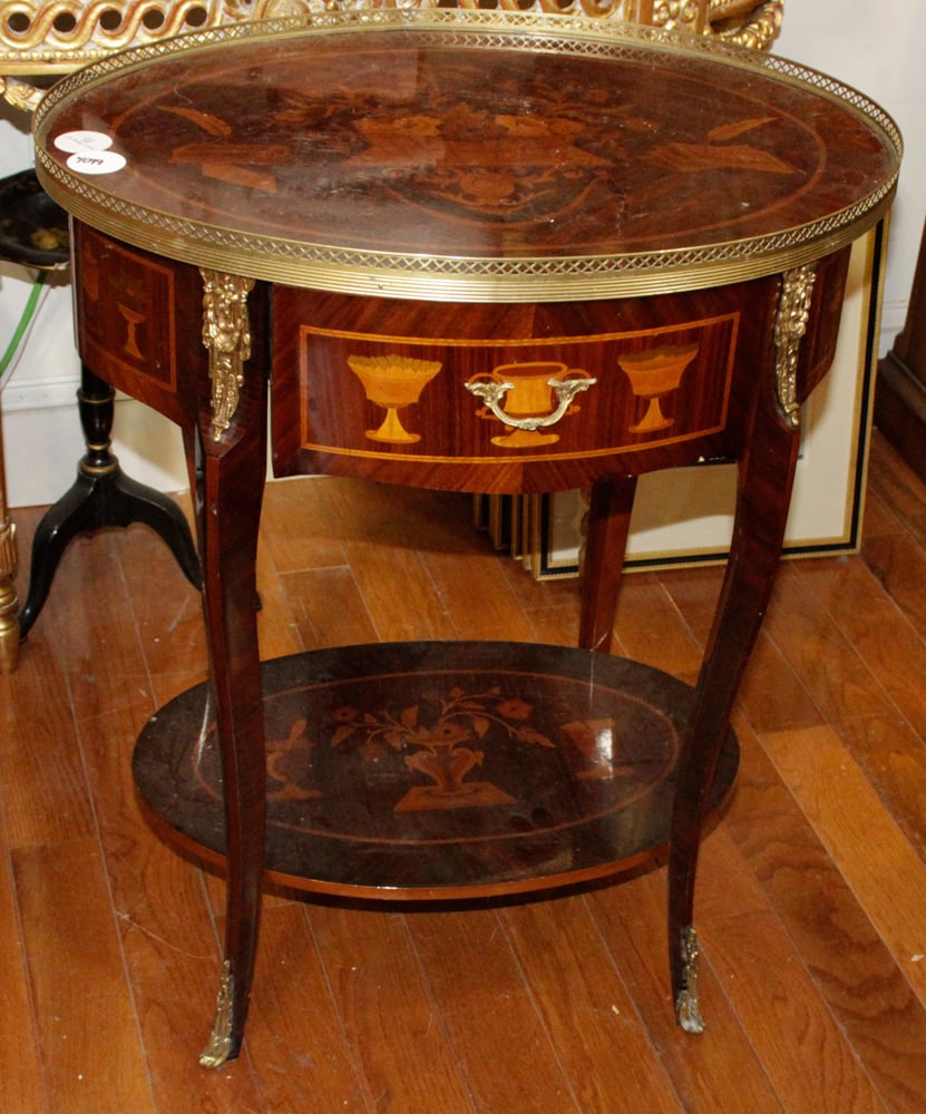 Mahogany Marquetry Inlaid Oval Table: Mahogany marquetry inlaid oval table, 30" H x 24" W x 18" D. Provenance: From a famous Park Avenue, New York hotel.