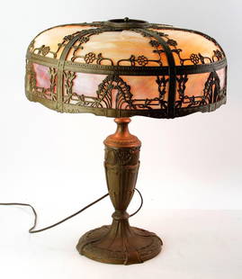 Bradley and Hubbard Slag Glass Lamp: Slag glass lamp by Bradley and Hubbard circa 1915, lamp 22" H with base, shade 18 1/2" W x 7" D, crack in panel. Provenance: Needham, Massachusetts.