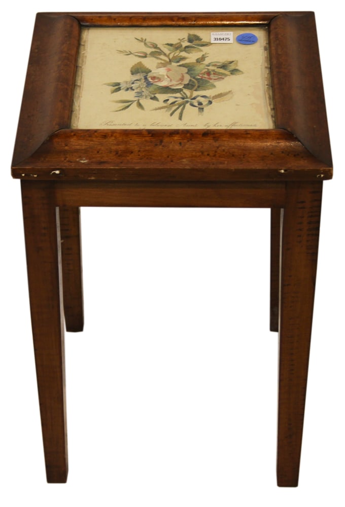 Brandy Table Having Embroidery Under Glass: Brandy table having floral embroidery under glass, in birdseye frame, 19" x 14" x13". Provenance: The Susie Hilfiger Collection.