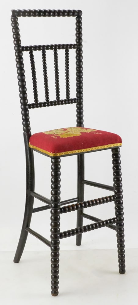 English Spool Highchair with Needlepoint Seat: English spool highchair with needlepoint seat, 38" H x 11" W x 9" D. Provenance: The Susie Hilfiger Collection.