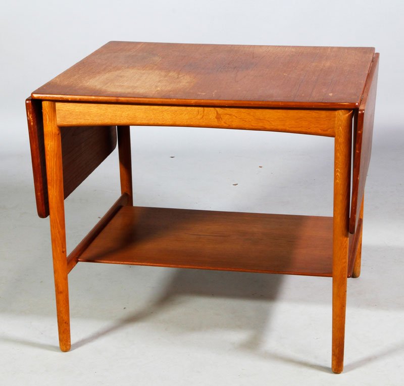 Wegner Teak Side Table: Hans J Wegner side table, teak, with side extensions, branded marks Fabrikat Andrtuck, Made in Denmark, with lower shelf, 23 1/2"h x 26 1/2"w (closed), 47 1/2"W (open) x 23 1/2"d. Scratches and staini