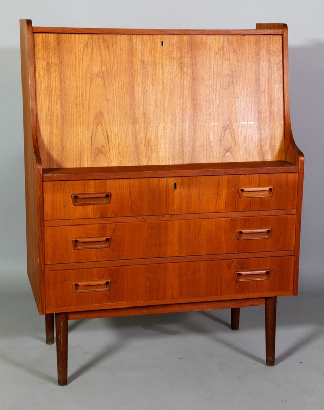 Teak 3-Drawer Desk: Contemporary teak three drawer desk having fold down lid on turned legs, plywood back, molded drawer pulls and brass escutcheons, 44 1/2'h x 33 1/4"w x 17"d. Provenance: from the estate of Robert C. B