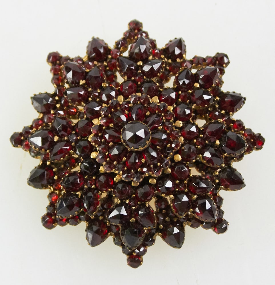 9k Yellow Gold and Garnet Victorian Brooch: 9k yellow gold and garnet Victorian brooch, 1 1/2" diameter. Approximately 11.4 grams TW. Provenance: Miami Beach, Florida collection. PLEASE NOTE: payment for silver, gold, jewelry, and coins must be