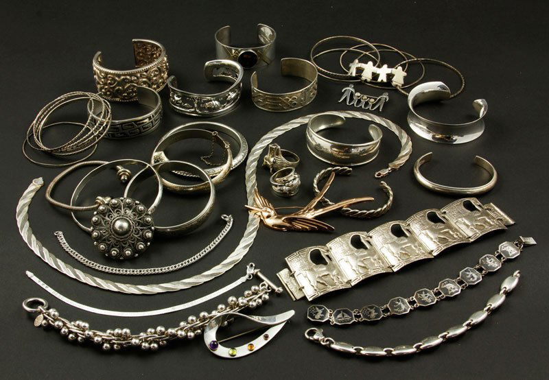 Collection of Sterling Jewelry: Collection of sterling jewelry, to include: two rings; one necklace; five pins (some with stones); five link bracelets; sixteen bangle bracelets; ten cuff bracelets; approximately 27.3 troy oz TW.