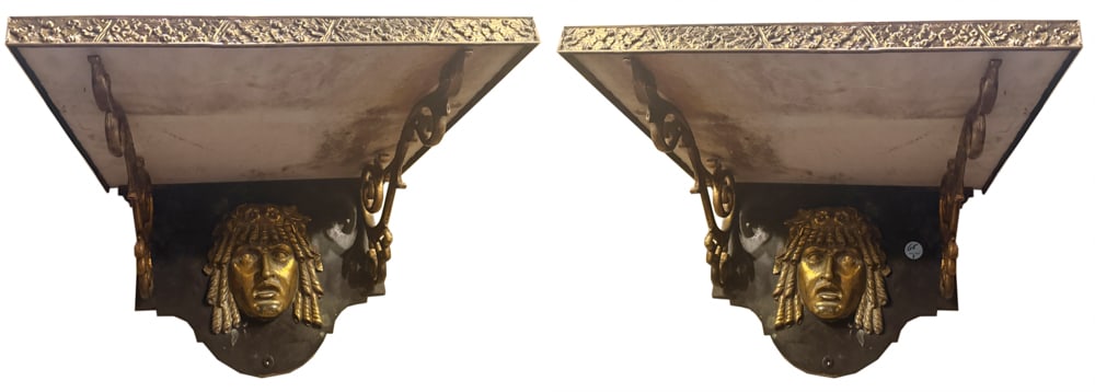 PAIR OF NEOCLASSICAL STYLE BRASSED AND PATINATED-BRONZE BRACKETS: A PAIR OF NEOCLASSICAL STYLE BRASSED AND PATINATED-BRONZE BRACKETS Each with rectangular rest supported by a cartouche-form backplate with a Classical mask and scrolling supports (part located in the