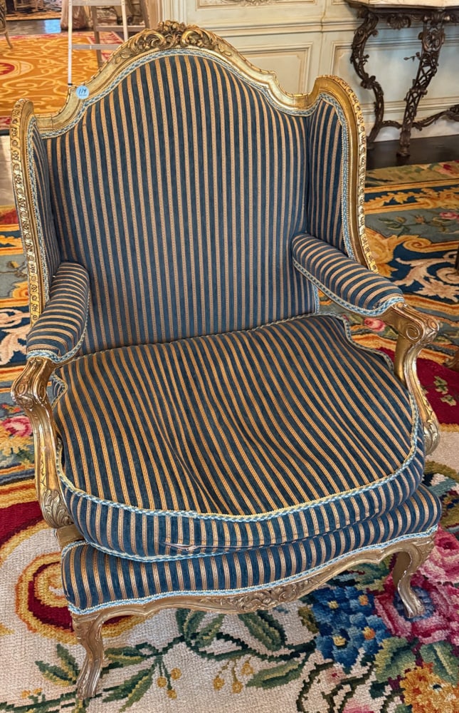 LOUIS XVI-STYLE WINGBACK CHAIR: LOUIS XVI-STYLE WINGBACK CHAIR - with blue and cream striped upholstery and gilt decorations, 43" H x 32" W x 29" D.