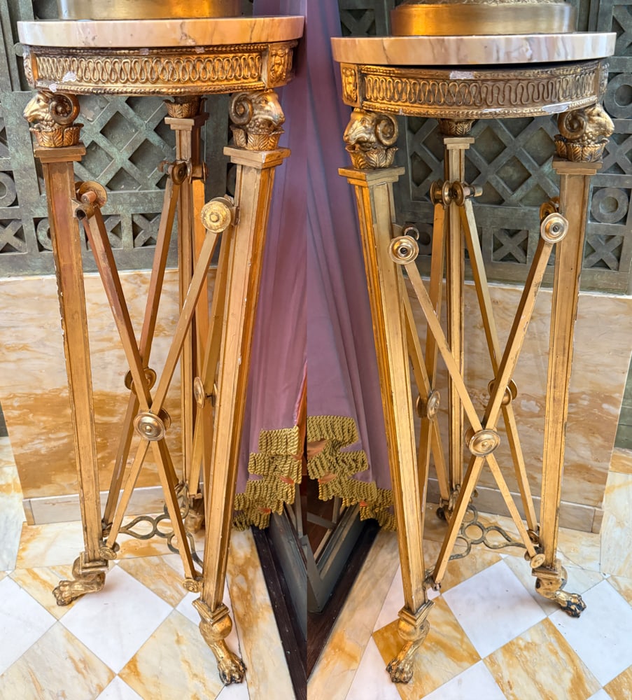 PAIR OF EMPIRE STYLE GILTWOOD PEDESTALS: A PAIR OF EMPIRE STYLE GILTWOOD PEDESTALS Late 19th/early 20th century Each with circular marble top above ram's headed supports joined by X-stretchers Height: 49 inches Diameter: 15 inches (2) Christ