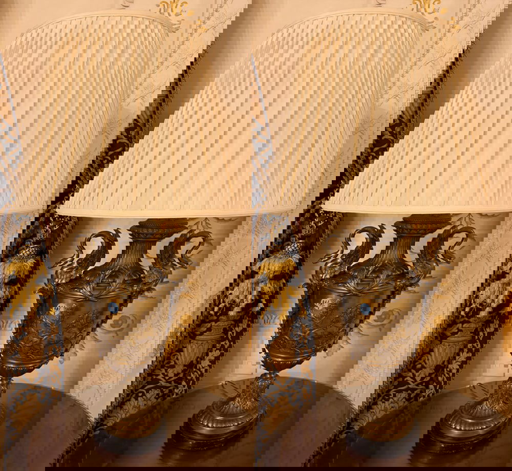 PAIR OF GILT-METAL URNS AND COVERS: A PAIR OF GILT-METAL URNS AND COVERS Each drilled and mounted as lamps with swan-form handle, the body molded with a Classical frieze, electrified Height: 21 inches (2) Christie's Appraisal 2005 - $1,