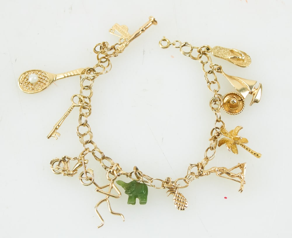 Gold Fill Charm Bracelet with (6) 14k Gold Charms: Gold fill charm bracelet with (6) charms marked 14k, remaining charms not tested, 7 1/2" L. Approximately 20.3 grams TW. Provenance: Woburn, Massachusetts collection. PLEASE NOTE: payment for silver,