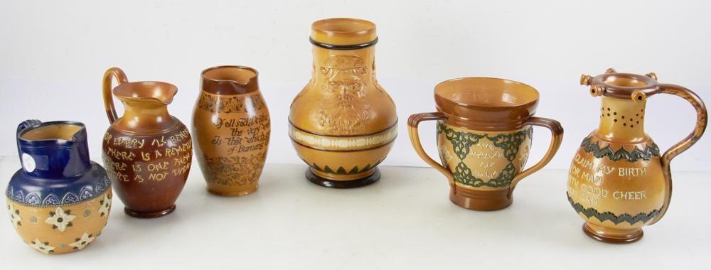 Collection of Late19th/Early 20th C Doulton Lambeth Pottery: Collection of late 19th/early 20th century English Doulton Lambeth salt-glazed pottery pieces to include: circa 1880 puzzle jug; loving cup; Bacchus motif wine jug; motto jugs, six (6) pieces total, a