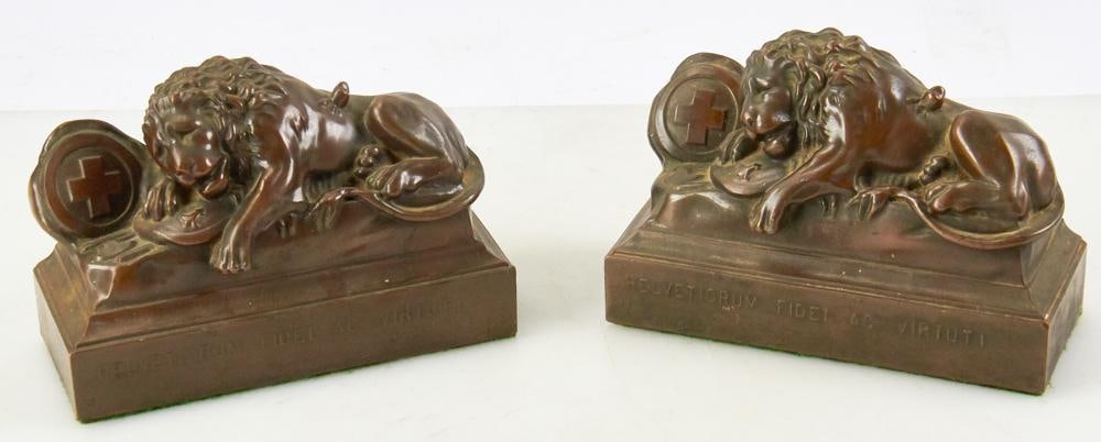 Pair of Bronze Figural Bookends, Lion of Lucerne: Pair of bronzed figural bookends depicting the Lion of Lucerne, titled "Helvetia Fidei ac Virtutis", 5" H x 7 1/2" W. Good condition. Provenance: Estate of Dalia Zikas, Melrose, Massachusetts.