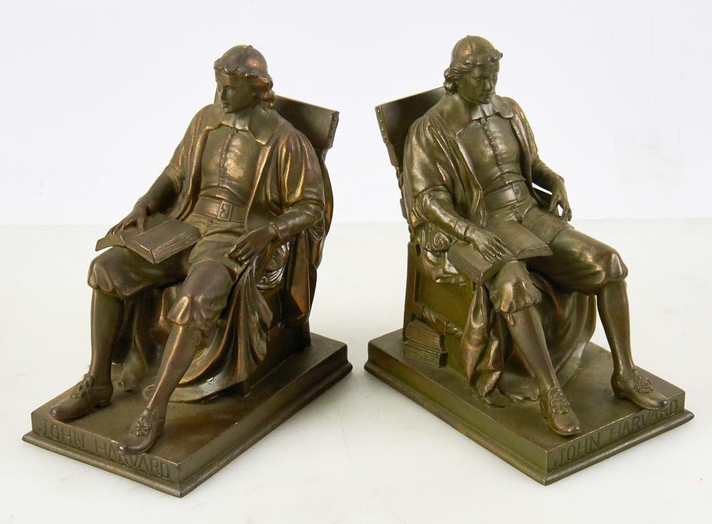 Pair of Daniel C. French Bronze Bookends of John Harvard: Pair of bronze figural bookends depicting John Harvard, marked on base "Daniel C. French Pat Appl For", 7 1/2" H. Good condition. Provenance: Estate of Dalia Zikas, Melrose, Massachusetts.