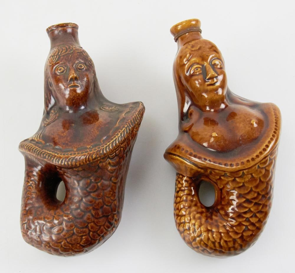 Two Ship's Figurehead Motif Redware Flasks: Two ship's figurehead motif redware flasks, 7 1/2" H. Good condition. Provenance: Estate of Dalia Zikas, Melrose, Massachusetts.